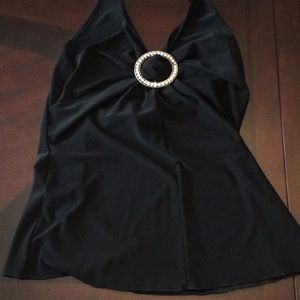 Black halter top. Round rhinestone pin